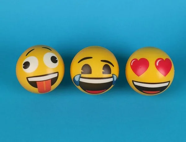 Emoji balls on blue background