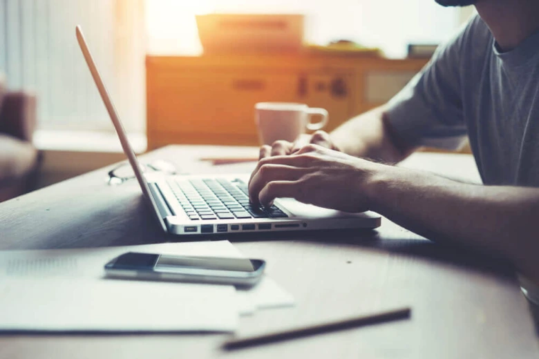 Person typing on laptop at desk