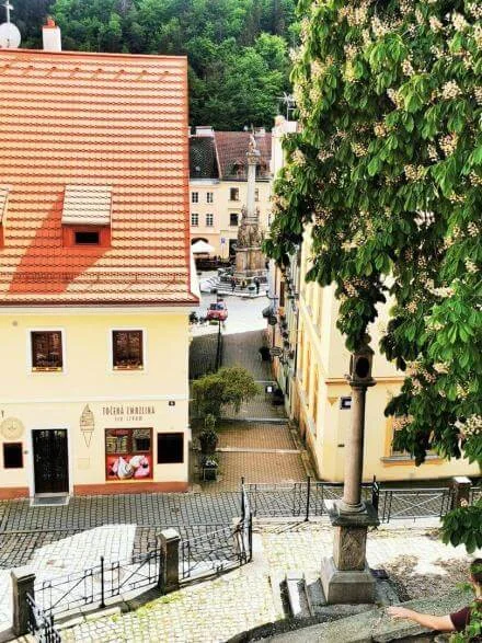 Pohled na náměstí v Lokti s historickými domy a fontánou.