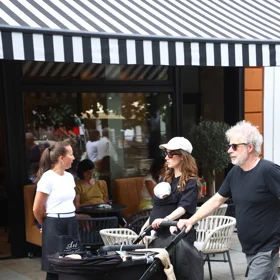Family with stroller outside cafe