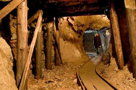 Podzemní galerie v Teplicích s dřevěnými stropy a kolejemi.