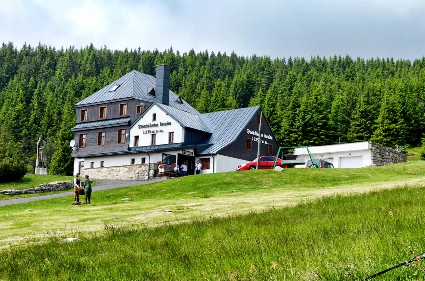 Dvořákova bouda na svahu s lesním pozadím