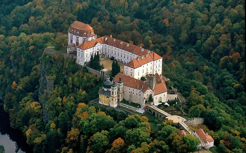Zámek Vranov nad Dyjí na skále v lese.
