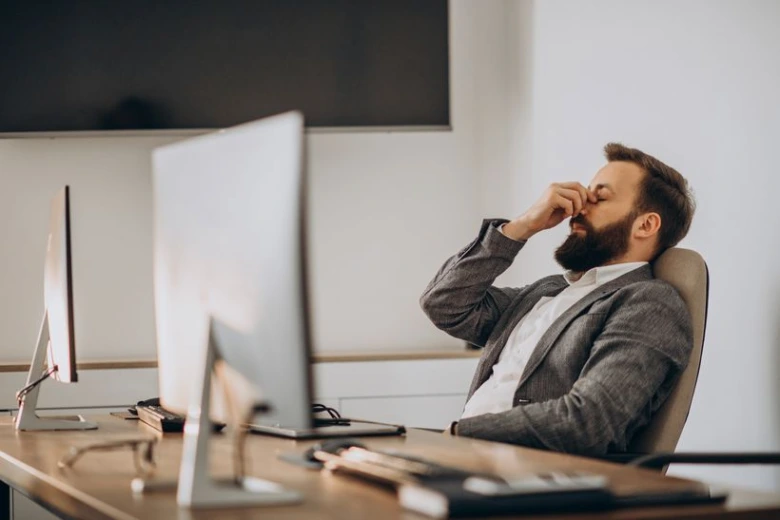 Tired businessman at desk