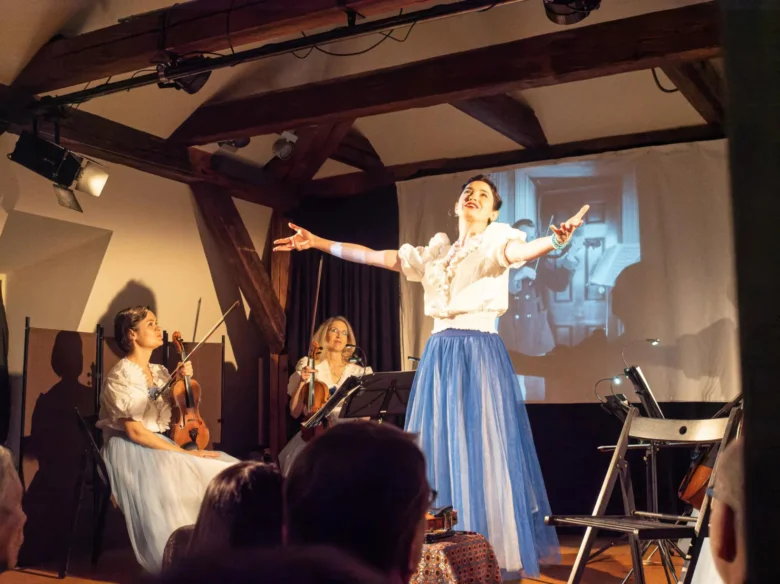 Female singer with violinists on stage