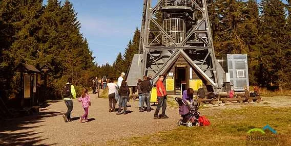 Turisté u nohy rozhledny v Peci pod Sněžkou.